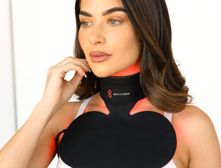 woman wearing red light neck and chest mask, during red light session